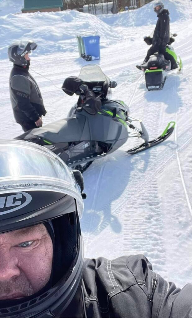 Doug and his ride crew on snowmobiles in Quebec